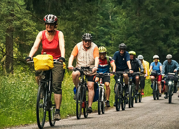 Gruppe von Menschen auf Fahrrädern im Wald